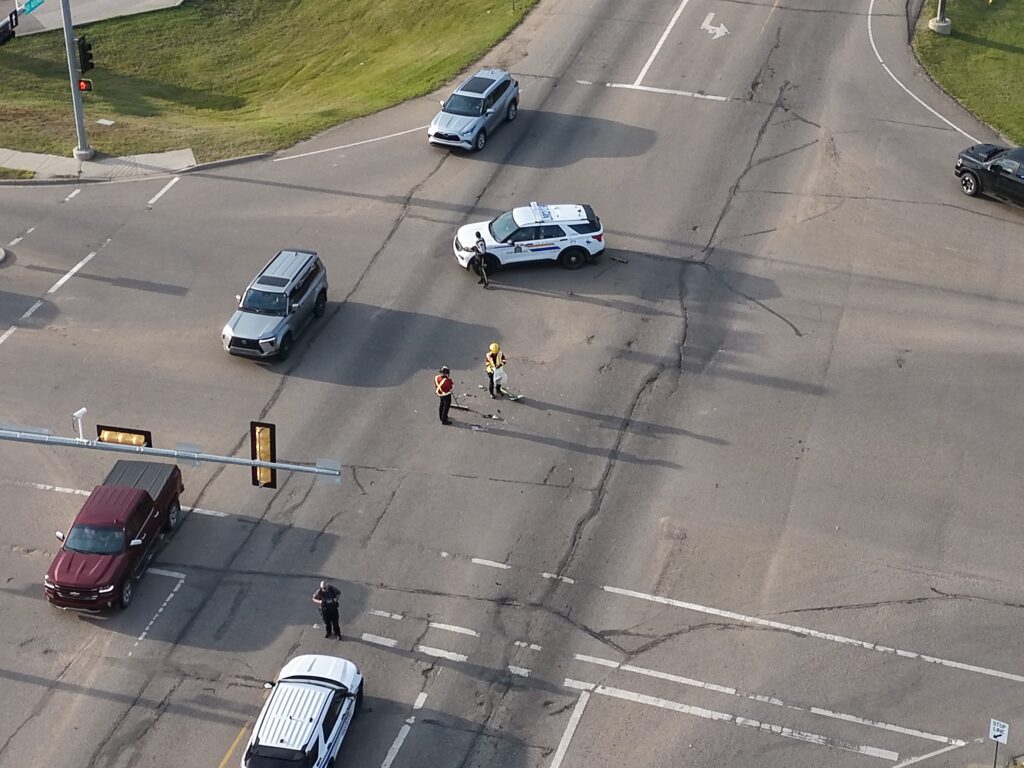Firefighters clear debris from a collision site in Lloydminster. 