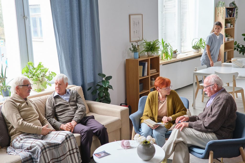 seniors relaxing and chatting in bright living roo 2026 09 22 00 34 09 utc