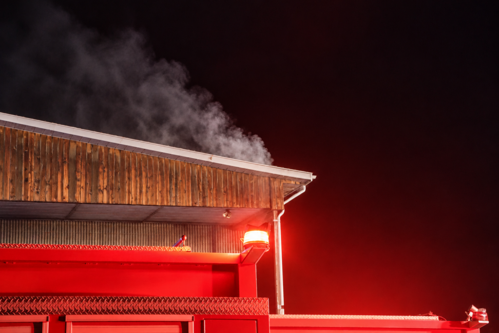 Smoke plume under red emergency lights